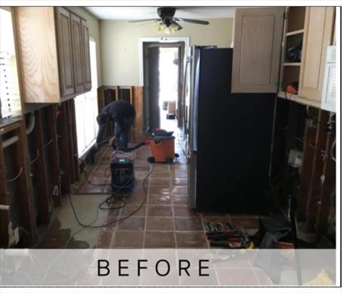 This kitchen has been damaged by fire resulting in removal of cabinets and drywall.