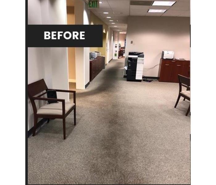 dirty carpet in office with chair, copier and desk 