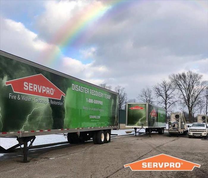 A rainbow appeared after a storm in the background of our trucks 